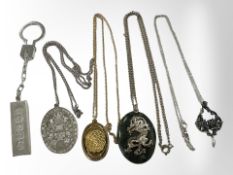 A silver ingot keychain and four pendants, one silver-gilt example,