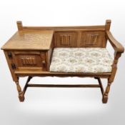 An oak linen fold telephone seat,