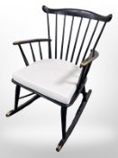 An ebonised rocking chair