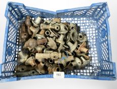 A crate of vintage metal door handle collars