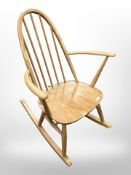 An Ercol elm and beech spindle back rocking chair (splits to back rest)