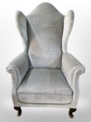 A 20th century wing back armchair
