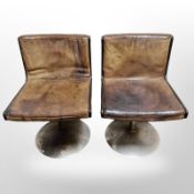 A pair of mid 20th century Scandinavian tan leather upholstered chairs on chrome supports,