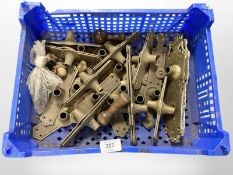 A crate of vintage brass door plates