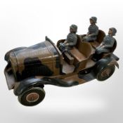 A German tin-plate wind-up car containing three soldiers, length 18cm.
