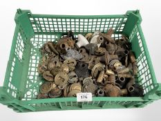 A crate of vintage brass and metal door handle collars,