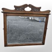 An Art Nouveau carved walnut mirror, width 67cm.