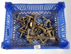 A crate of vintage brass door handles