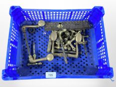 A crate of vintage brass door handles and fixings