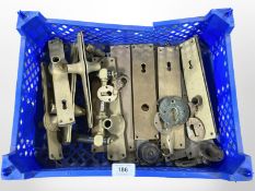 A crate of brass door plates