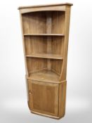 An Ercol elm corner cabinet,