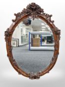 A heavily carved reproduction mirror,