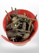 A tub of vintage brass door handles