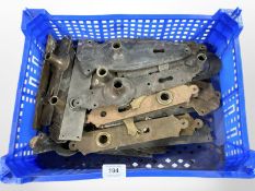 A crate of vintage brass door plates and fixings