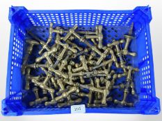 A crate of vintage brass door handles