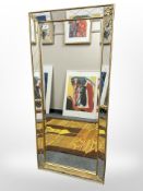 A contemporary bevelled mirror, 53cm x 116cm.