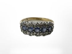 A yellow gold sapphire and diamond ring.