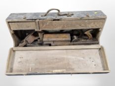 An antique joiner's toolbox containing woodworking planes.