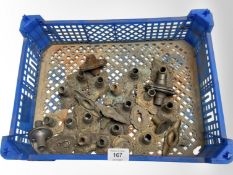 A crate of vintage metal door handle collars