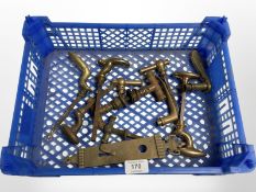A crate of brass door handles and a lock plate