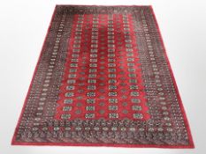 A machine-made rug of Turkoman design, 260cm x 190cm.