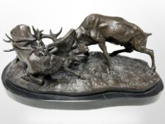 After Pierre-Jules Mêne, a bronze group of two stags locking antlers on black marble plinth,