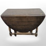 Two oak drop leaf dining tables