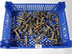 A crate of vintage brass 'T' shape door handles