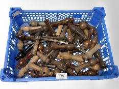 A crate of vintage wooden turned door handles