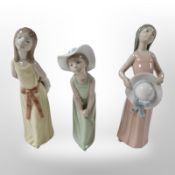 Three Lladró figures of girls in summer dresses, tallest 25cm.