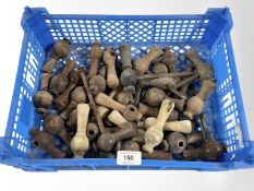 A crate of antique turned wooden door handles.