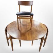 A 1960's teak circular extending dining table,