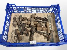A crate of vintage wooden door handles