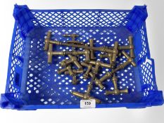 A crate of vintage brass 'T' shaped door handles