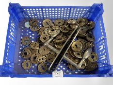 A crate of key escutcheons and two stainless steel door handles.