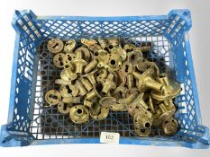 A crate of vintage brass door handle collars
