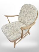 An Ercol elm and beech easy chair in floral upholstery
