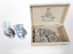 Two Royal Crown Derby seated cat paperweights, one gold stopper and one silver,