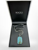 A silver turquoise pendant
