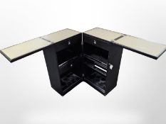 An ebonised folding storage cabinet,