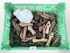 A crate of turned wooden door handles