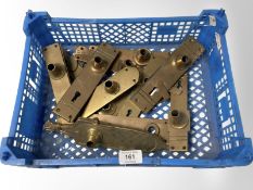 A crate of brass door handle plates