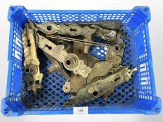 A crate of vintage brass door plates