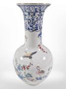 A contemporary Italian porcelain vase decorated with exotic birds, height 40cm.