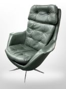 A dark green buttoned leather swivel lounge chair on chrome support,