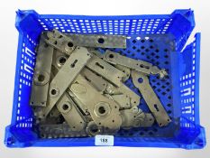 A crate of vintage brass door plates