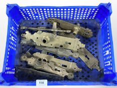 A crate of vintage brass door plates