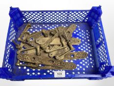 A crate of vintage brass door handles and lock plates