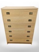 A Danish oak veneer six drawer chest with brass drop handles,