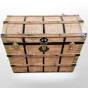 An early 20th century metal wooden and canvas bound domed topped trunk,